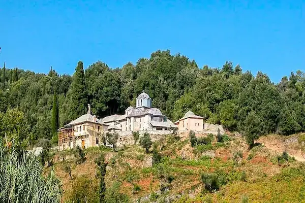 The Greek Skete of Timiou Prodromou, a dependency of Iviron Monastery, on a lush green hill in Mount Athos.